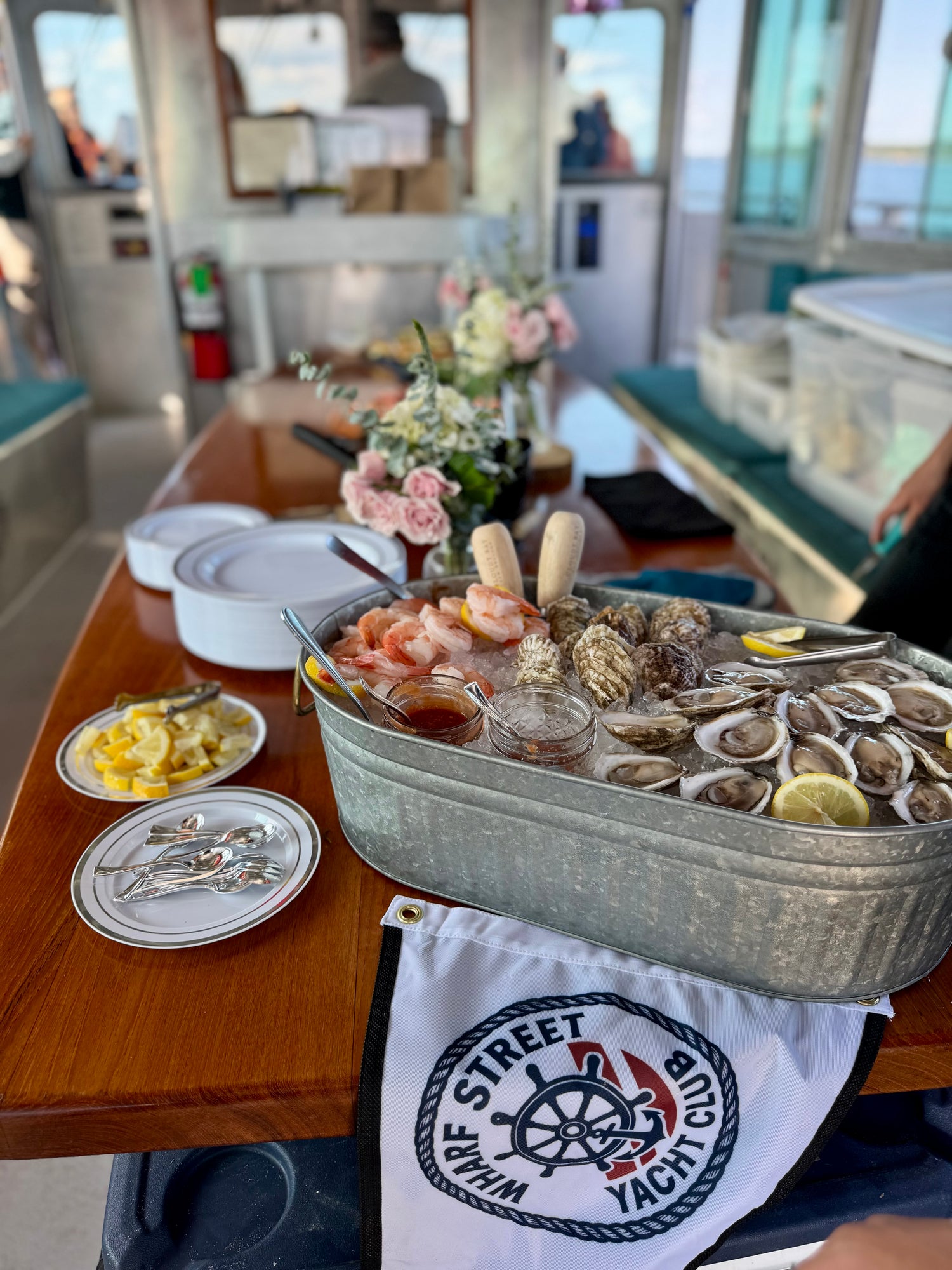 Seafood platter on a table with 'White Street Yacht Club' towel in the foreground